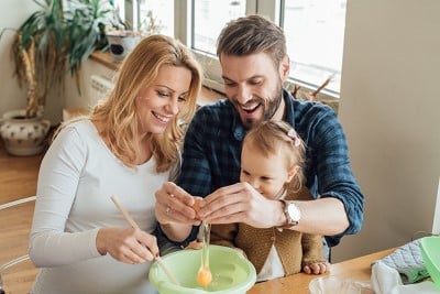 A family baking with eggs